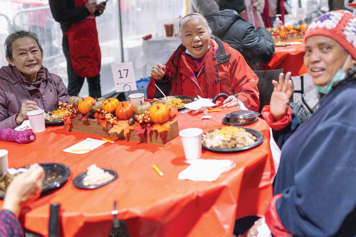 Guest smiling with Thanksgiving meal