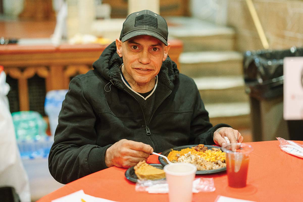 Guest smiling with Thanksgiving meal