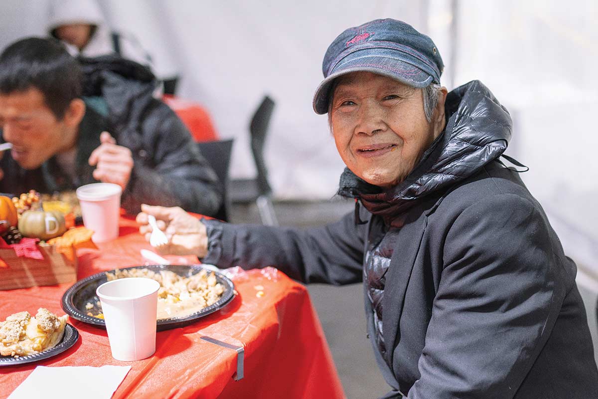 Guest smiling with Thanksgiving meal